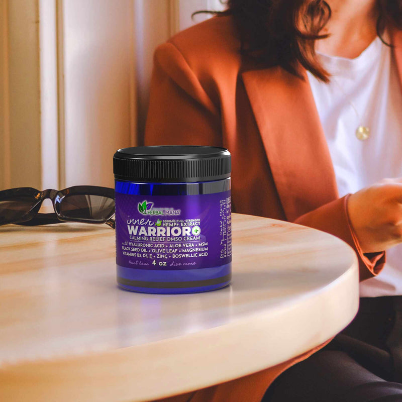 Inner Warrior+ Calming Relief DMSO Cream (5000mg) Sitting on the table next to a woman