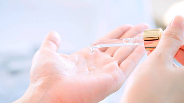 Applying cbd oil to hands for pain relief, close up