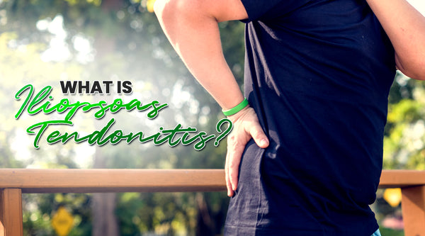 what is iliopsoas tendonitis iliopsoas tendonitis symptoms causes natural treatment for iliopsoas tendonitis man wearing dark blue shirt holding his lower back in pain wearing green bracelet outside with green and black text