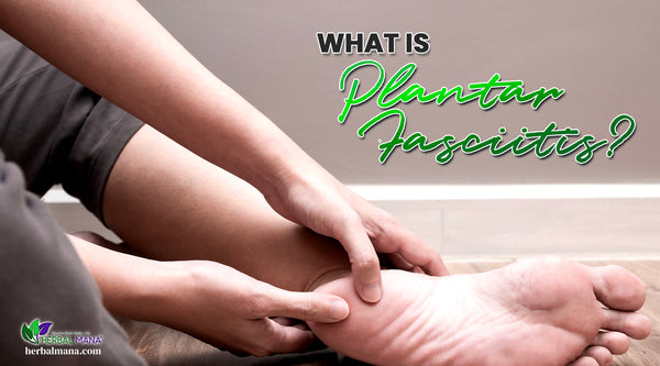 what is plantar fasciitis the causes of plantar fasciitis symptoms natural remedies for plantar fasciitis essential oils woman holding the heel of her foot in pain sitting on wood floor next to the gray wall