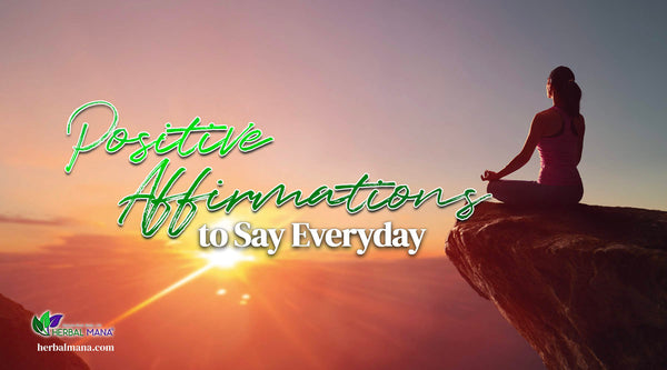 positive affirmations to say everyday woman meditating on rock cliff at sunrise green white text overlay