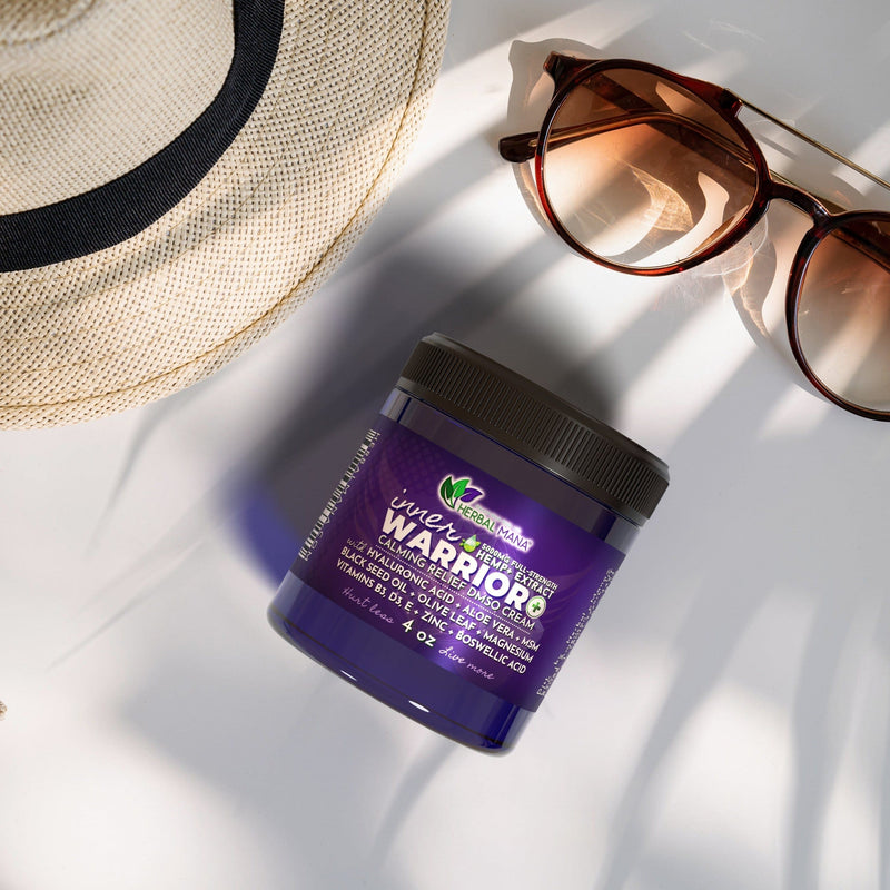 Inner Warrior+ Calming Relief DMSO Cream (5000mg) laying next to a sun hat and sunglasses in the shade of palm trees