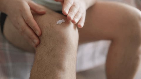Person applying Royal Warrior cream for joint pain relief